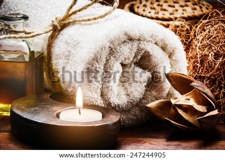 Spa setting with towel and candle in brown tone