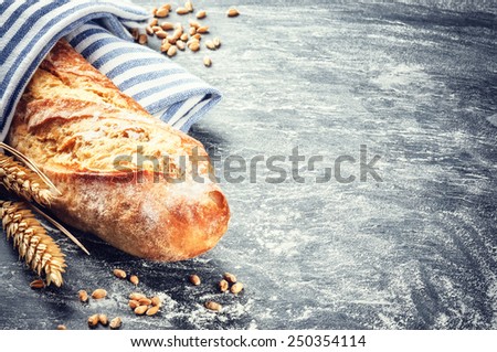 Freshly baked baguette in rustic setting with copyspace