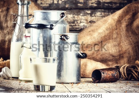 Farm setting with fresh milk in various bottles and cans