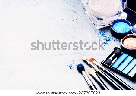 Various makeup products in blue tone with copyspace