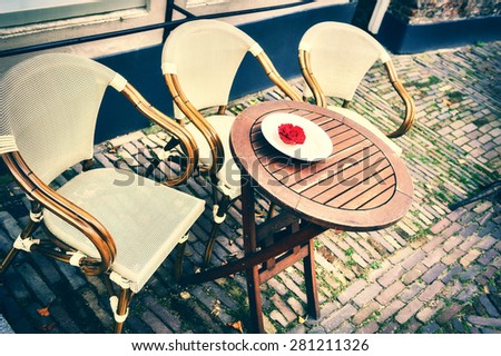 Cafe terrace in small European city at summer day