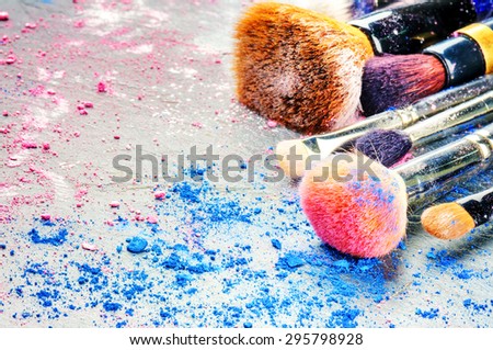 Makeup brushes and crushed eyeshadow
