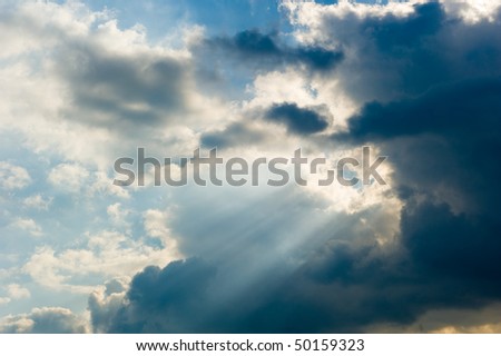 Sun rays streaming trough an opening of the clouds
