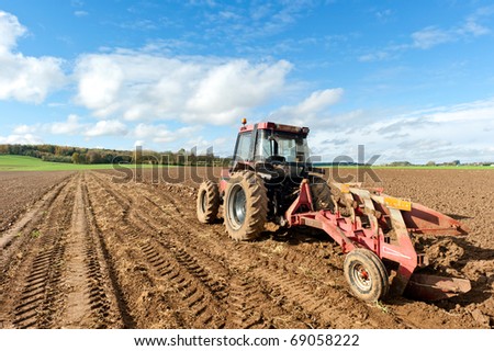 Tractors Plowing Field