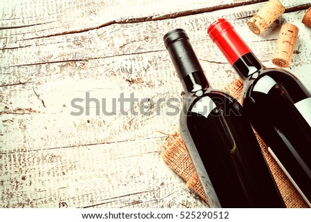 Setting with bottles of red wine and corks. Wine list concept with copy space