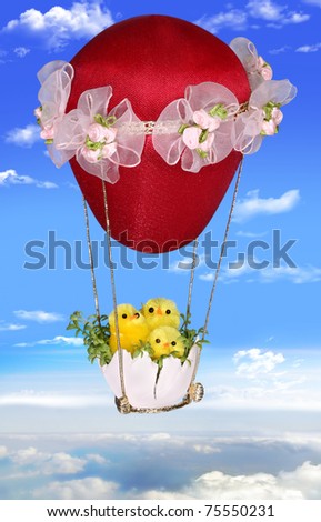 Three Easter chickens on a balloon soaring in the sky. Background for an Easter card with a place for your text. Handiwork.