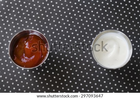 Small containers filled with ketchup and ranch dressing