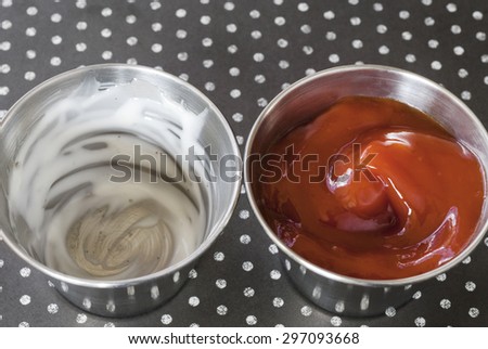 An untouched side of ketchup and an empty side of ranch dressing