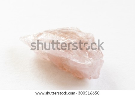 A single rough cut piece of rose quartz from northern California. It is unpolished and in its original, natural form.
