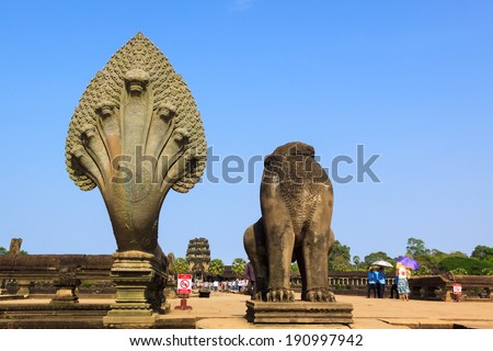 ANGKOR, CAMBODIA - APR 07: The statue of naga snake and lion without head at the entry into Angkor Wat. On Apr 7, 2014.