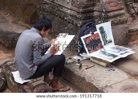 ANGKOR, CAMBODIA - APR 6: Artist drawing pictures at Preah Khan temple, Siem Reap, Cambodia. On April 6, 2014.