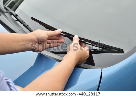 man hand picking up windscreen wiper