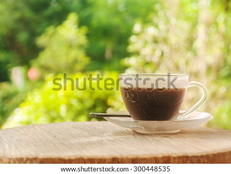 Morning coffee, Black coffee in old a cup of coffee on wood table and morning light background
