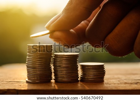 Saving money for prepare concept, Hand with rows of coins and account for finance and banking concept, Hand with money coin stack growing business
