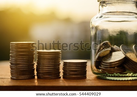 Saving money for prepare concept, Rows of coins with account for finance and banking concept, Glass bottle with money coin stack growing business