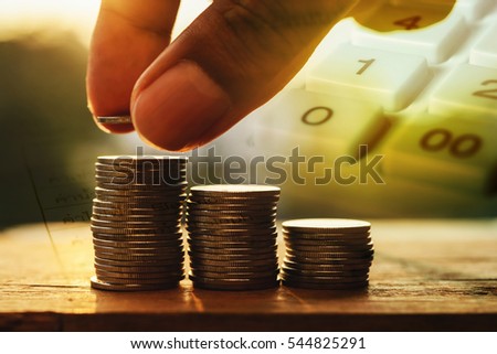 Double exposure hand with stack of coins and utility bill and calculator with account banking for finace, Money and finance concept