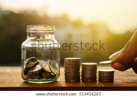 Hand with rows of coins and account for finance and banking concept, Hand with money coin stack growing business, Saving money concept