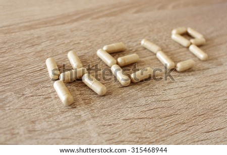 Word help created by medicine pills on the table