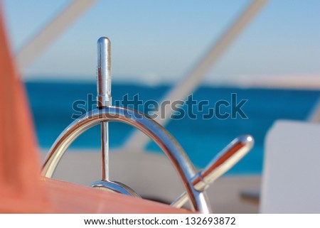 Captain steering wheel on boat