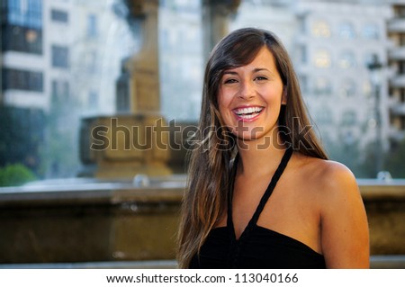 Portrait of an attractive smiling woman in urban background