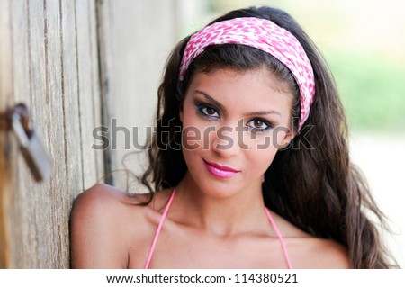 Portrait of a beautiful mixed woman with pink hair scarf
