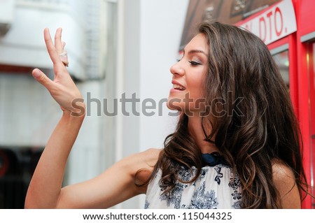 Portrait of attractive young woman trying on a ring at a jewelry