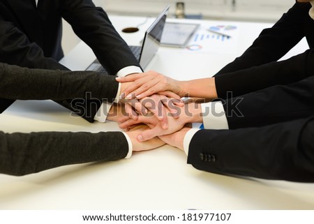 Business team showing unity with their hands together