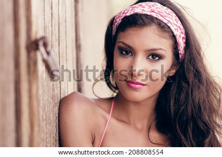 Portrait of a beautiful mixed woman with pink hair scarf