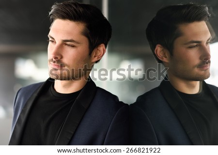 Portrait of an attractive man, model of fashion, wearing modern suit.