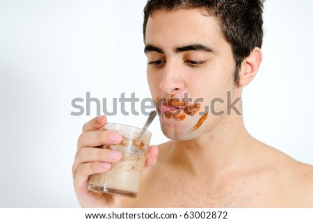 Young guy drinking a chocolat smoothie
