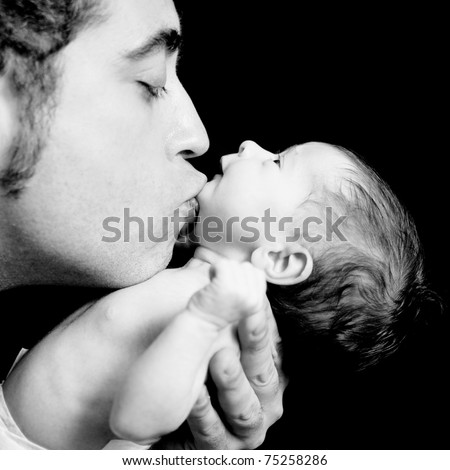 Father kissing his daughter\'s chin