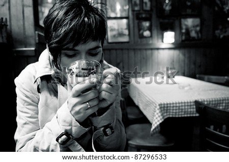 Woman drinking a hot coffee at the diner