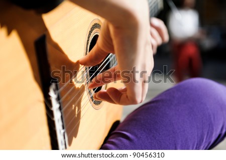 Woman hand playing the Spanish guitar