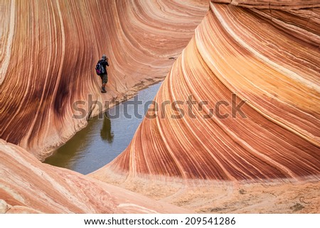 14th August 2012 - Page, Arizona. A Lucky tourist taking a picture at The Wave, amazing flowing rock formation in Arizona, near Page. Only 20 people per day are admitted to visit the site.