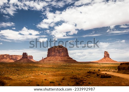 Monument Valley Navajo Tribal Park, mittens and clouds in the blue sky. American Landscape, natural wonder