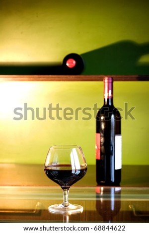 bottle of red wine and glass in a wine bar