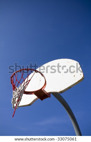 Old basketball hoop with ripped net
