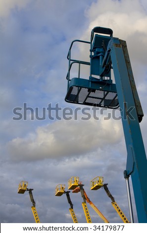 Mobile cranes against dramatic sky