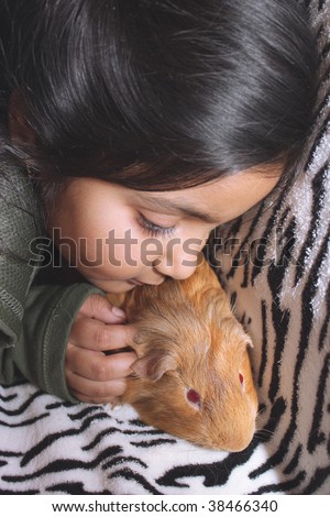 Little east indian girl and guinea pig
