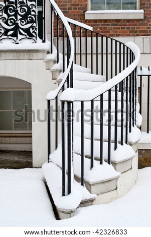 Stairs to the house covered by heavy snow