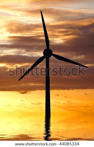 A wind turbine in the sea under sunset