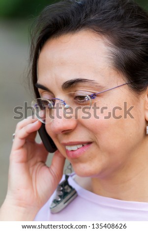 Nice girl while receiving some interesting news on the phone