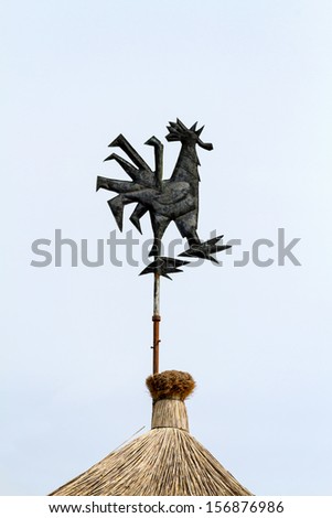 Wind cock direction on blue sky