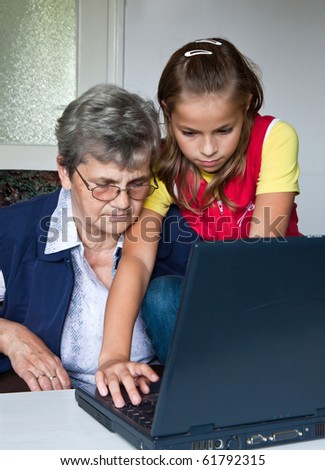 Grandchild teach your grandmother to play with a computer
