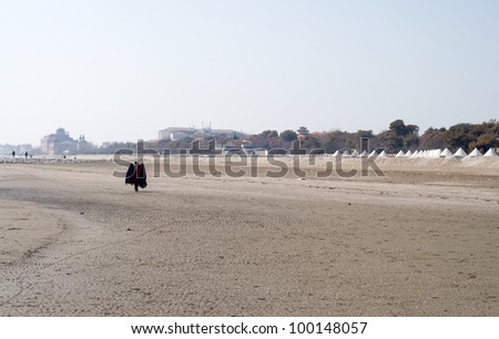 Coat seller on beach in Venice, Italy