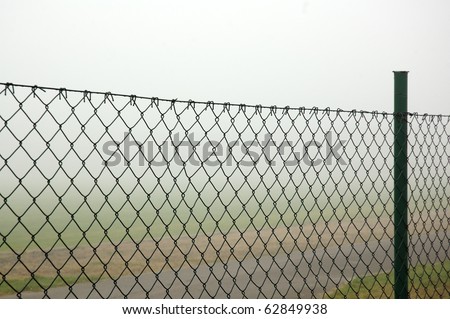 Fog behind the wire fence