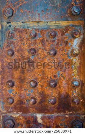 Rusty rivets on a steel panel