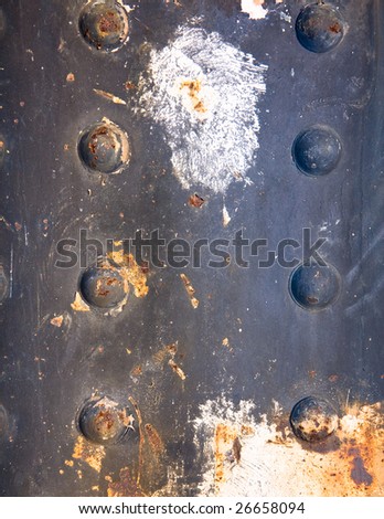 Rusty rivets on a steel panel