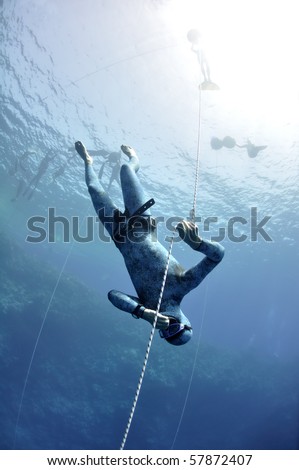 Free diver makes preparation dive near the safety line by breaststroke. Picture shows a part of free diving training session in Blue Hole, Dahab, Egypt