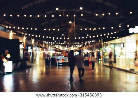 Blurred background : people shopping at market fair, blur background with bokeh.